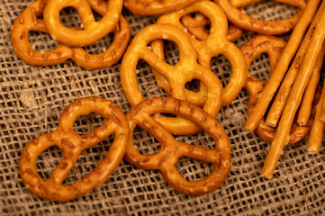 Salted breadsticks and salted pretzels scattered on the table.