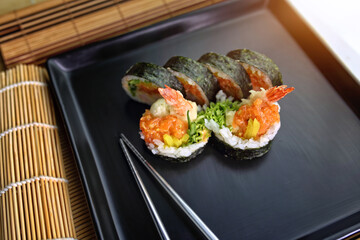 fish sushi on a ceramic plate in a traditional asian recipe