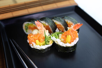 fish sushi on a ceramic plate in a traditional asian recipe