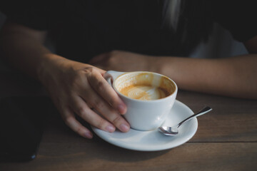 women enjoy drinking coffee at a cafe while having coffee Cup of hot cappucino