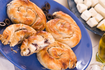 Pastry swirls with cheese and olive filling.
