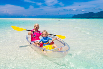 Kids kayaking in ocean. Family in kayak in tropical sea