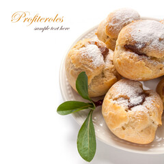 Homemade profiteroles with chocolate cream and powdered sugar