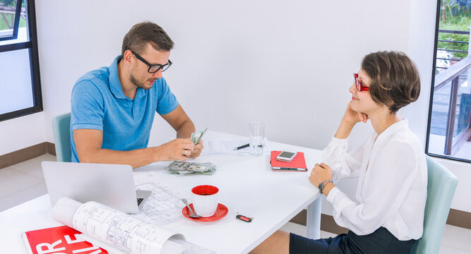 Young Man Gives Cash To The Agent Realtor As Collateral Deals