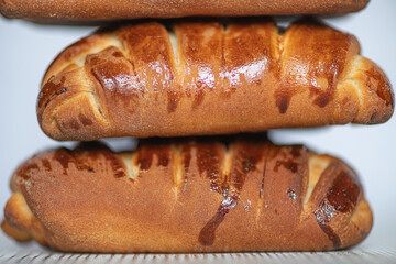 Appetizing fresh homemade buns on a wooden background, close-up.