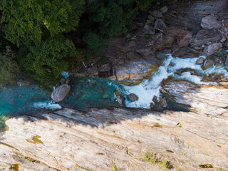 Aerial view of a glacier river with crystal clear turquoise water at val verzasca