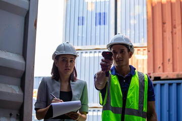 Businessman worker open door of cargo container worker then use barcode scanner check the product for import and export and work with co-worker women at container yard