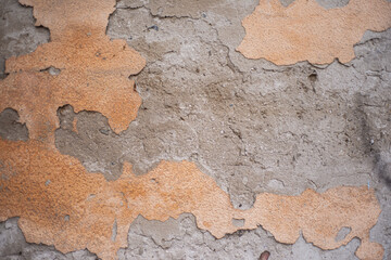 Old wall surface with crumbling plaster. Old brick wall for background. Cement grunge background. The dilapidated facade of the house with damaged plaster. Abstract copy space.