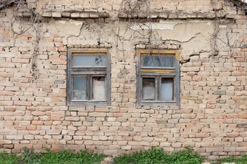 old abandoned building with rustic windows and brick walls