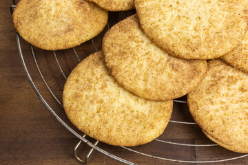 heap of snickerdoodle cookies with sugar and cinnamon on a cooling rack