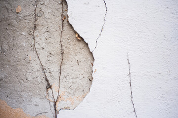 Old wall surface with crumbling plaster. Old brick wall for background. Cement grunge background. The dilapidated facade of the house with damaged plaster. Abstract copy space.
