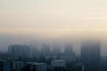 Prague's residential district in foggy early morning. Building's silhouettes through morning fog.  Aerial photography. Misty cityscape from above.