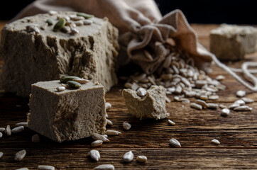 Halva of sunflower. Halva on wooden background.