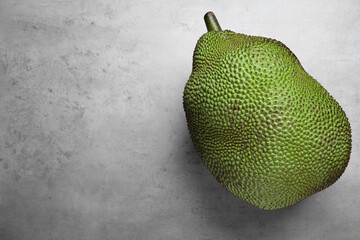 Delicious exotic jackfruit on light grey table, top view. Space for text