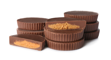 Cut and whole peanut butter cups isolated on white