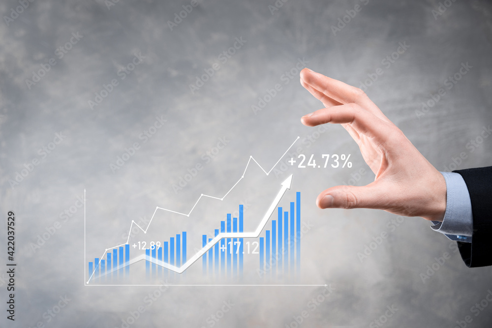 Wall mural businessman holding graph growth and increase of chart positive indicators in his business.investmen