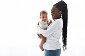 African American mom hugging her cute infant