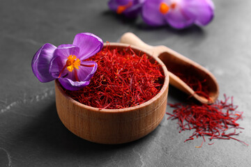 Dried saffron and crocus flower on grey table