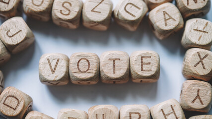 Obraz na płótnie Canvas Vote word concept. Wooden Blocks close up view