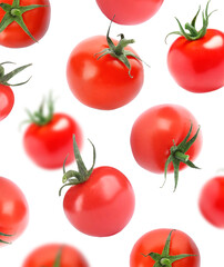 Fresh organic cherry tomatoes falling on white background