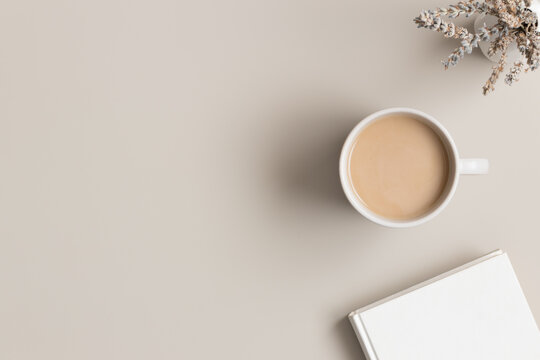 White Book, Cup Of Coffee And A Lavender On The Beige Table.  Flat Lay With Blank Copy Space.