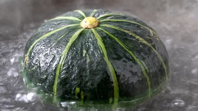 Delicious food, small green pumpkin in boiling water