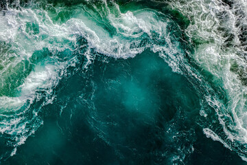 Waves of water of the river and the sea meet each - obrazy, fototapety, plakaty