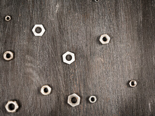 Dark wooden surface with scratches and nuts on background - wooden black shabby background