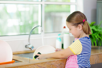 Child washing dishes.