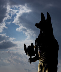Statue of mythology jackal anubis sky and clouds