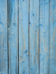 Naklejka premium Old wooden planks painted with peeling blue paint.