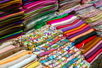 Sale of multi-colored fabrics at the fair. Retail trade in the store.