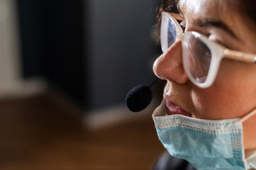 Portrait of a woman call center operator in a lowered mask