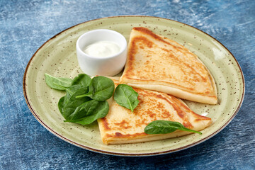 tasty breakfast with pancakes and herbs