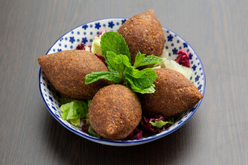 Fototapeta na wymiar Kibbeh Middle Eastern dish of ground lamb with bulgar wheat and seasonings, eaten cooked or raw.