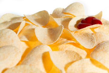 Crispy potato chips with drop of ketchup background