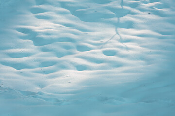 Smooth rolling, untouched pack of snow in sunlight.