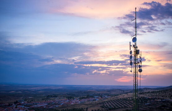 Broadcast station antennas up of hill of over little town