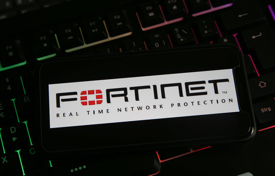 Viersen, Germany - March 1. 2021: Closeup of mobile phone with logo lettering of fortinet anti virus computer network security software on keyboard