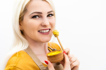 closeup of female mouth and spoon with honey