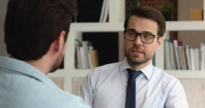 Two business partners negotiating at meeting in office. Colleagues share opinions about project, make business solution, sit at workplace. Job interview HR manager and applicant communication concept
