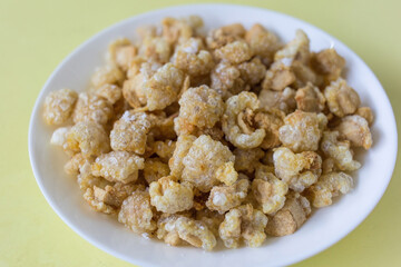 Pork crackling (pork snack, pork scratching) is fried pork skin as snack and we can eat it with noodles in Thai food style.