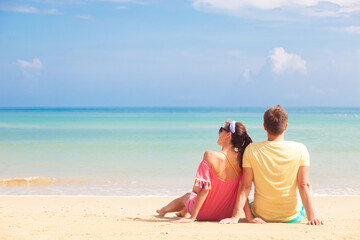 Fototapeta premium happy young couple lying and having fun on a tropical beach