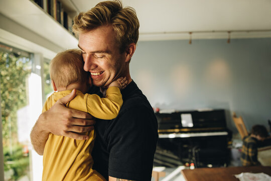 Man on paternity leave taking care of a new born baby