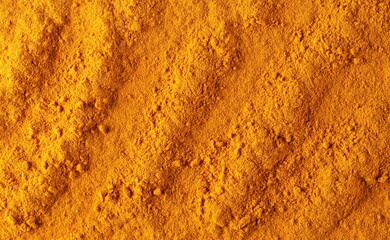 Turmeric (Curcuma) powder pile background and texture, top view