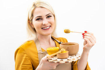 smiling young woman with bowl of honey on white background