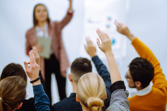 Business People Raising Hand Up To Ask Question With Speaker, To Agree Or Vote For Comments In Seminar Conference. Business Group Meeting Seminar Training Concept.