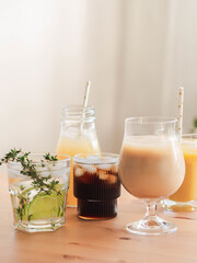 Various refreshing non-alcoholic drinks in glasses with ice.