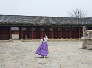 Woman wearing Hanbok (traditional Korean clothes) in Gyeongbokgung Palace in Seoul, Korea