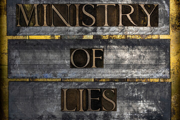 Ministry of Lies text on vintage textured silver grunge copper and gold background